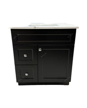 Black bathroom vanity with one door, two drawers and a white quartz countertop