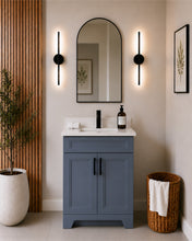 Pearl 24" dark grey bathroom vanity with black hardware and white quartz countertop, styled in a modern bathroom with wood slat accent wall