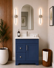 Pearl 30" navy blue bathroom vanity with two drawers, brushed nickel hardware and white quartz countertop, styled in a modern bathroom with wood slat accent wall