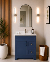 Pearl 30" navy blue bathroom vanity with two drawers, brushed nickel hardware and white quartz countertop, styled in a modern bathroom with wood slat accent wall