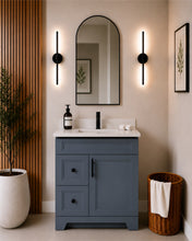 Pearl 30" dark grey bathroom vanity with two drawers, black hardware and white quartz countertop, styled in a modern bathroom with wood slat accent wall