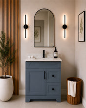 Pearl 30" dark grey bathroom vanity with two drawers, black hardware and white quartz countertop, styled in a modern bathroom with wood slat accent wall