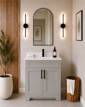 Pearl 30" light grey bathroom vanity with black hardware and white quartz countertop, styled in a modern bathroom with wood slat accent wall