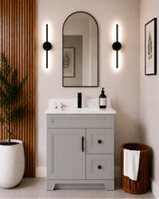 Pearl 30" light grey bathroom vanity with two drawers, black hardware and white quartz countertop, styled in a modern bathroom with wood slat accent wall