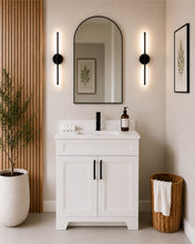 Pearl 30" white bathroom vanity with black hardware and white quartz countertop, styled in a modern bathroom with wood slat accent wall