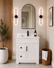 Pearl 30" white bathroom vanity with two drawers, black hardware and white quartz countertop, styled in a modern bathroom with wood slat accent wall