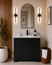 Pearl 36" black bathroom vanity with drawers, black hardware and white quartz countertop, styled in a modern bathroom with wood slat accent wall