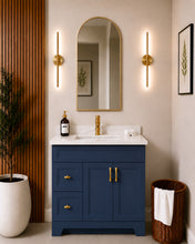 Pearl 36" navy blue bathroom vanity with drawers, gold hardware and white quartz countertop, styled in a modern bathroom with wood slat accent wall