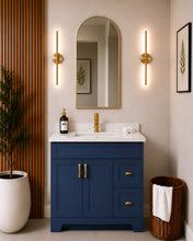 Pearl 36" navy blue bathroom vanity with drawers, gold hardware and white quartz countertop, styled in a modern bathroom with wood slat accent wall
