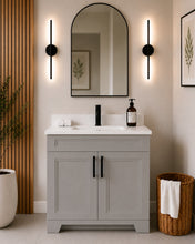 Pearl 36" light grey bathroom vanity with black hardware and white quartz countertop, styled in a modern bathroom with wood slat accent wall