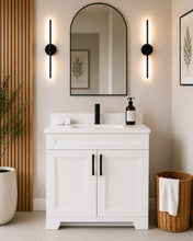 Pearl 36" white bathroom vanity with black hardware and white quartz countertop, styled in a modern bathroom with wood slat accent wall