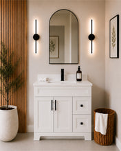 Pearl 36" white bathroom vanity with drawers, black hardware and white quartz countertop, styled in a modern bathroom with wood slat accent wall