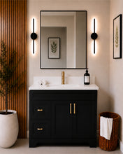 Pearl 42" black bathroom vanity with drawers, brushed gold hardware and white quartz countertop, styled in a modern bathroom with wood slat accent wall