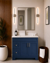 Pearl 42" navy blue bathroom vanity with drawers, brushed nickel hardware and white quartz countertop, styled in a modern bathroom with wood slat accent wall