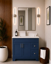 Pearl 42" navy blue bathroom vanity with drawers, brushed nickel hardware and white quartz countertop, styled in a modern bathroom with wood slat accent wall