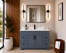 Pearl 48" dark grey bathroom vanity with drawers, black hardware and white quartz countertop, styled in a modern bathroom with wood slat accent wall