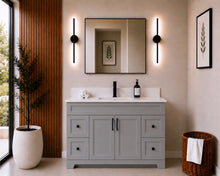 Pearl 48" light grey bathroom vanity with drawers, black hardware and white quartz countertop, styled in a modern bathroom with wood slat accent wall