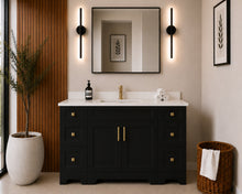 Pearl 54" black bathroom vanity with six drawers, brushed gold hardware and white quartz countertop, styled in a modern bathroom with wood slat accent wall