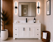 Pearl 60" white single sink bathroom vanity with black hardware and white quartz countertop, styled in a modern bathroom with wood slat accent wall