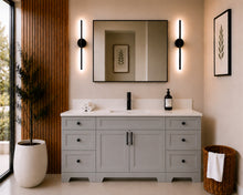 Pearl 72-inch light grey single-sink bathroom vanity with black hardware, quartz countertop, and matte black faucet, styled in a modern bathroom with a black-framed mirror, black wall sconces, and wood slat accent wall.