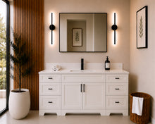 Pearl 72-inch white single-sink bathroom vanity with black hardware, quartz countertop, and matte black faucet, styled in a modern bathroom with a black-framed mirror, black wall sconces, and wood slat accent wall.