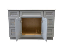 Light grey solid wood cabinet with open doors and quartz countertop