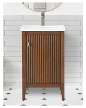 Walnut vanity with ceramic sink for small bathroom space.