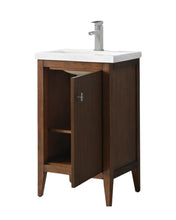 Walnut fluted bathroom vanity with ceramic sink and open cabinet door.